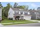 Charming two-story home with blue shutters, a manicured lawn, and a welcoming front porch at 119 Loon Dr, Summerville, SC 29483