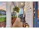Inviting front porch with rocking chairs, hanging plants, and decorative lanterns at 119 Loon Dr, Summerville, SC 29483