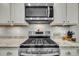 Modern kitchen featuring stainless steel gas range, microwave, and tile backsplash at 119 Loon Dr, Summerville, SC 29483