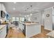 Open-concept kitchen with granite countertops, island seating, and view to the living room at 119 Loon Dr, Summerville, SC 29483
