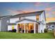 Beautiful screened-in porch with modern furniture and flowing curtains in a well-maintained home at dusk at 119 Loon Dr, Summerville, SC 29483