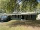 Charming single-story home featuring solar panels and a convenient carport for covered parking at 1206 Hawthorne Rd, Hanahan, SC 29410
