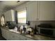 Kitchen view with granite countertops, white cabinets, stainless steel appliances, and a bright window over the sink at 1206 Hawthorne Rd, Hanahan, SC 29410