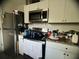 A kitchen with stainless steel appliances, white cabinets, and dark granite countertops showcasing a practical culinary space at 1206 Hawthorne Rd, Hanahan, SC 29410