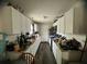 Galley kitchen with white cabinets and plenty of counter space at 1206 Hawthorne Rd, Hanahan, SC 29410