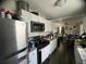Bright kitchen flows into the living area, featuring stainless steel appliances, white cabinets, and dark granite countertops at 1206 Hawthorne Rd, Hanahan, SC 29410