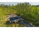 Aerial view of a delightful single-story home with a well-kept lawn and a driveway through mature trees at 121 Dotson St, Harleyville, SC 29448