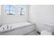 Bright bathroom featuring a large soaking tub with granite counters and a modern toilet at 121 Dotson St, Harleyville, SC 29448