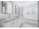 Bright bathroom with double vanity, granite counters, and large soaking tub under a window at 121 Dotson St, Harleyville, SC 29448
