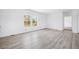 Bright and airy living room with sleek floors, a large window, and a view into the adjacent rooms at 121 Dotson St, Harleyville, SC 29448