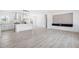 Open-concept living area featuring sleek floors, modern finishes, and an adjacent kitchen with stainless steel appliances at 121 Dotson St, Harleyville, SC 29448