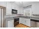 Bright kitchen with white cabinetry, granite counters, stainless appliances, and hardwood flooring at 1215 Redeemer Dr, Hanahan, SC 29410