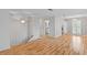 Open-concept living room with hardwood floors and elegant lighting at 1215 Redeemer Dr, Hanahan, SC 29410