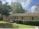 Well-maintained brick home featuring shutters, a manicured lawn, and a front porch at 122 Gator Dr, Goose Creek, SC 29445