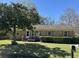 Charming brick home with well-maintained landscaping and a welcoming front porch at 122 Gator Dr, Goose Creek, SC 29445