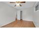 Bright bedroom featuring hardwood floors, ceiling fan, and closet space at 1318 Foster St, Charleston, SC 29407