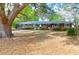 Charming red brick house featuring mature trees, large front yard, and inviting curb appeal at 1318 Foster St, Charleston, SC 29407
