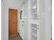 Hallway with hardwood closet door and white shelving at 1318 Foster St, Charleston, SC 29407