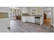 A kitchen featuring white cabinetry, tile floors, and a stainless steel dishwasher at 1318 Foster St, Charleston, SC 29407