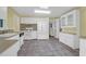 Functional kitchen features white cabinets, white appliances, and tile floors at 1318 Foster St, Charleston, SC 29407