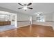 Open floorplan living room with hardwood floors, ceiling fans, and seamless access to dining area at 1318 Foster St, Charleston, SC 29407