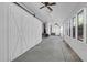 Enclosed sunroom with many windows, brick accent, and overhead fans at 1318 Foster St, Charleston, SC 29407