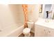 Bright bathroom featuring an orange-patterned shower curtain, tub, vanity, and modern fixtures at 143 Yarrow Way, Moncks Corner, SC 29461