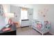 Charming Bedroom with crib and changing table is decorated with colorful accents at 143 Yarrow Way, Moncks Corner, SC 29461