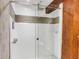 Modern bathroom shower with glass doors, white subway tile, and rustic wood accents, offering a blend of contemporary and traditional design at 15 N Adgers Wharf, Charleston, SC 29401