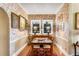 Dining area with floral wallpaper and brick features, bathed in natural light from the window at 15 N Adgers Wharf, Charleston, SC 29401