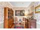 Elegant dining room with floral wallpaper, antique furniture, and decorative pieces, perfect for formal gatherings at 15 N Adgers Wharf, Charleston, SC 29401