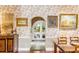 Stylish dining room with floral wallpaper, vintage furniture, brick accent, and decorative accents at 15 N Adgers Wharf, Charleston, SC 29401
