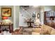 Inviting foyer with a staircase, featuring a small table with flowers and artwork, creating a warm and stylish welcome at 15 N Adgers Wharf, Charleston, SC 29401