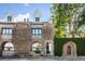 Charming brick home featuring unique architectural details, dormer windows, and an arched doorway at 15 N Adgers Wharf, Charleston, SC 29401