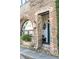 Charming brick exterior with arched window, flower basket, lantern, and a glimpse of the entryway at 15 N Adgers Wharf, Charleston, SC 29401
