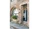 Charming brick exterior with arched window, flower basket, lantern, and a glimpse of the entryway at 15 N Adgers Wharf, Charleston, SC 29401