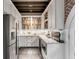 Bright kitchen featuring white cabinets, stainless steel appliances, granite countertops, and built-in bookcase at 15 N Adgers Wharf, Charleston, SC 29401