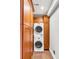 Efficient laundry area with stacked washer/dryer and ample storage cabinets, perfect for maximizing space in a modern home at 15 N Adgers Wharf, Charleston, SC 29401