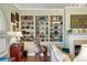 Bright living room with stylish built-in shelving, a decorative fireplace, and unique zebra statue at 15 N Adgers Wharf, Charleston, SC 29401
