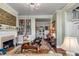 Charming living room featuring a fireplace, built-in bookshelves, and view to the adjacent dining area at 15 N Adgers Wharf, Charleston, SC 29401