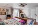 Light-filled main bedroom with hardwood floors, a ceiling fan, and a sliding door to a patio at 15 N Adgers Wharf, Charleston, SC 29401