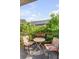 Cozy outdoor patio featuring a round table and two chairs, surrounded by lush greenery at 15 N Adgers Wharf, Charleston, SC 29401
