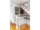 Elegant staircase featuring white railings, hardwood steps, and decorative artwork, adding a touch of sophistication to the home at 15 N Adgers Wharf, Charleston, SC 29401