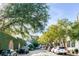 A charming street with old homes, lush trees, and parked cars on a cobblestone street at 15 N Adgers Wharf, Charleston, SC 29401
