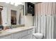 Bathroom featuring granite countertop, white cabinets, toilet, and decorative shower curtain near a walk-in closet at 1502 Thoroughbred Blvd, Johns Island, SC 29455