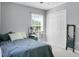 Bedroom with a window, closet, blue bed, side table, fan, and a full-length mirror at 1502 Thoroughbred Blvd, Johns Island, SC 29455