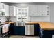 Well-lit kitchen with stainless steel sink, butcher block countertops and navy blue lower cabinets at 1502 Thoroughbred Blvd, Johns Island, SC 29455
