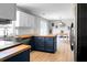 A wider view of the modern kitchen showing the butcher block countertops and eating area at 1502 Thoroughbred Blvd, Johns Island, SC 29455