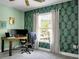 Office space showcasing a desk with dual monitors, striking leaf-patterned wallpaper, and a bright window view at 1502 Thoroughbred Blvd, Johns Island, SC 29455