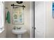 Small powder room with pedestal sink, rustic mirror and beach decor at 1502 Thoroughbred Blvd, Johns Island, SC 29455